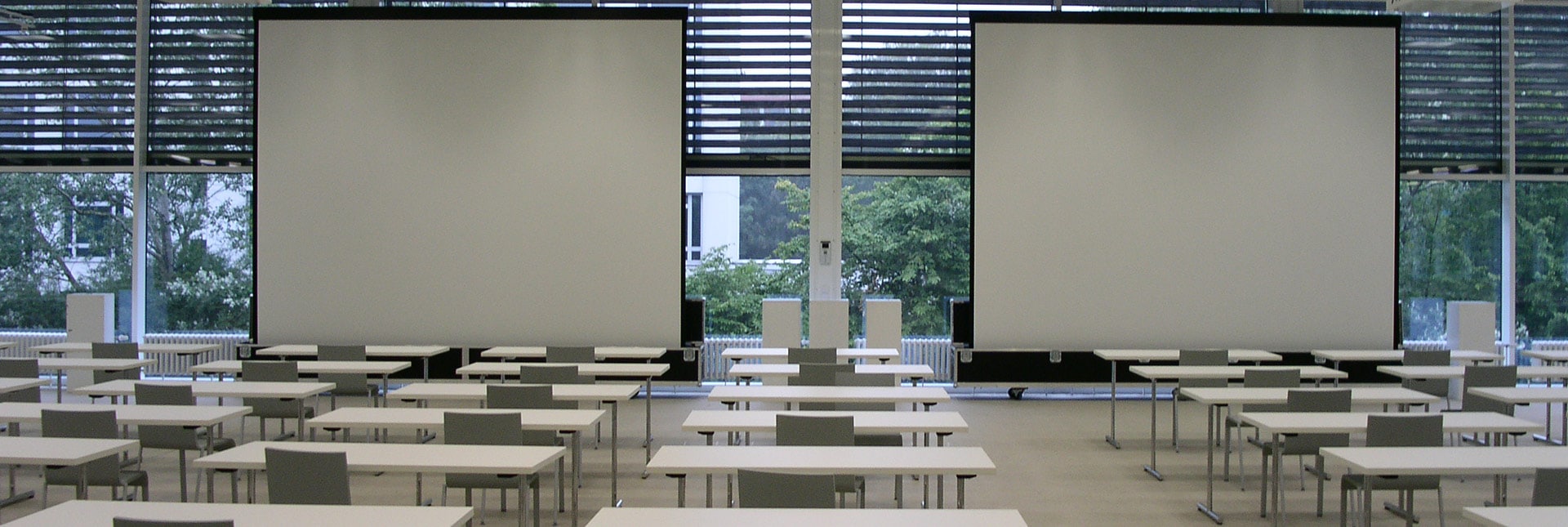 View to projector screen in wooden conference room